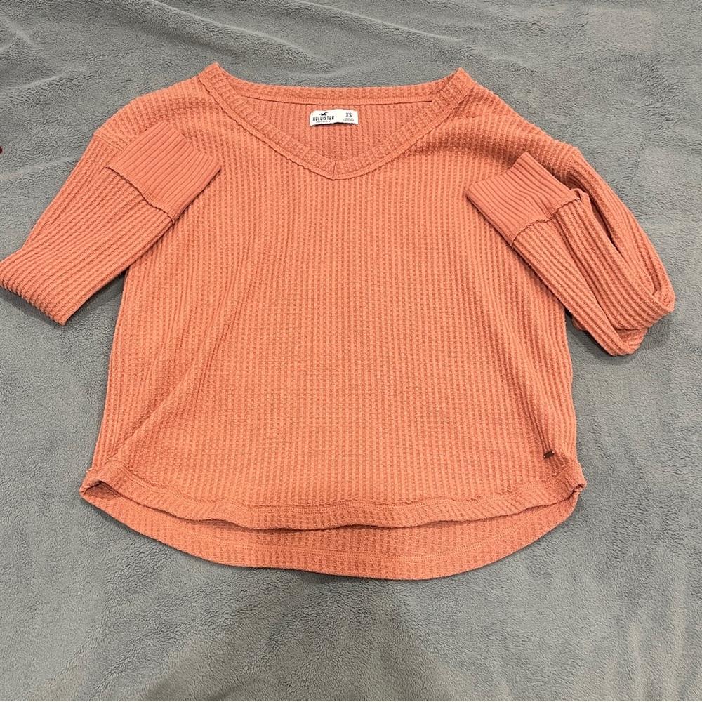 Salmon Holister waffle material sweater. Fairly worn. Size extra small.